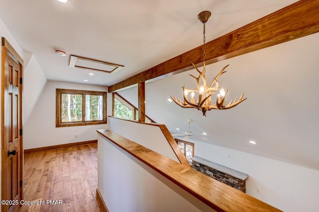 hall featuring vaulted ceiling with beams, recessed lighting, light wood-style floors, an upstairs landing, and baseboards