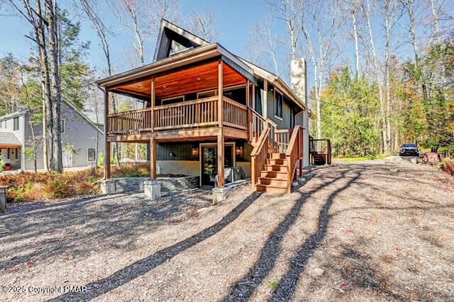 view of front of home featuring stairway and a wooden deck