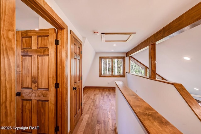 corridor with light wood-type flooring, lofted ceiling with beams, baseboards, and recessed lighting