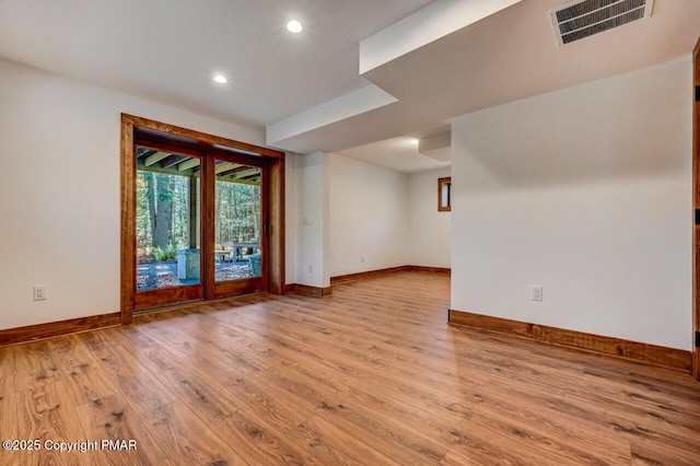 unfurnished room featuring baseboards, visible vents, wood finished floors, and recessed lighting