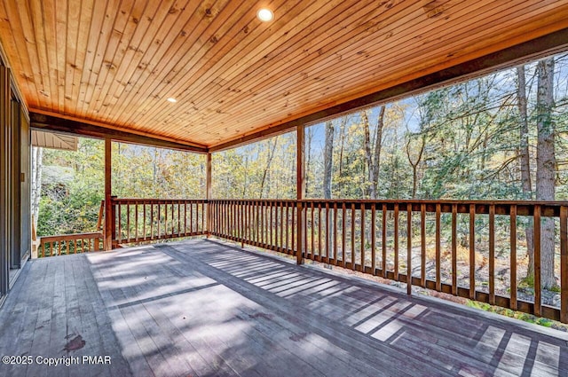 unfurnished sunroom featuring wood ceiling