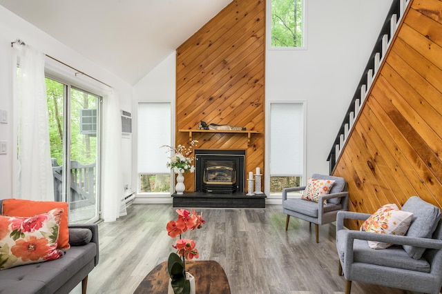 2162 Glasgow Dr, Bushkill, PA 18324 - living room with high vaulted ceiling, wooden walls, stairway, and wood finished floors