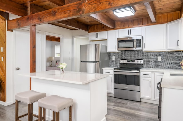 2162 Glasgow Dr, Bushkill, PA 18324 - kitchen with stainless steel appliances, a wooden ceiling with exposed beams, light wood-style floors, tasteful backsplash, and light countertops