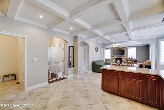 kitchen featuring a fireplace, coffered ceiling, and beam ceiling