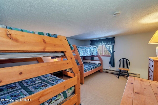 bedroom with a textured ceiling, baseboard heating, and carpet