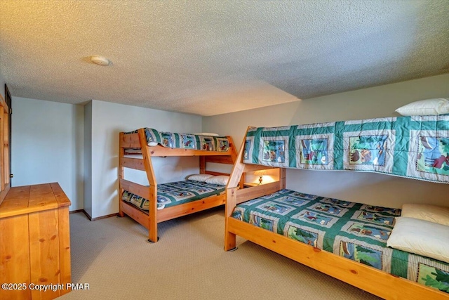 bedroom with carpet flooring, a textured ceiling, and baseboards