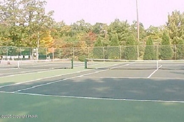 view of tennis court featuring fence