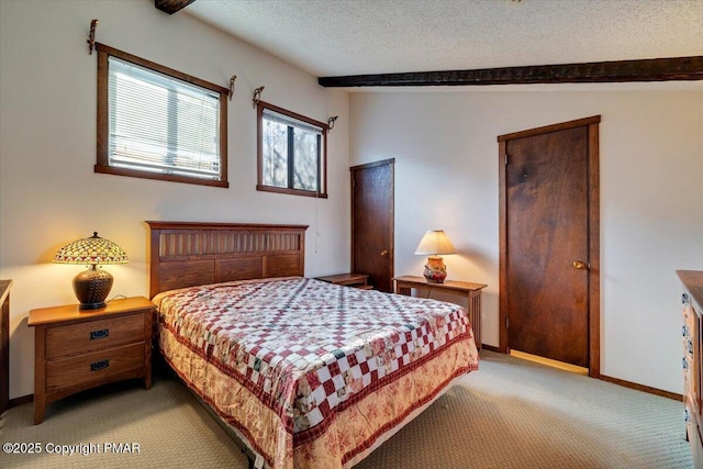 bedroom featuring light carpet, vaulted ceiling with beams, baseboards, and a textured ceiling