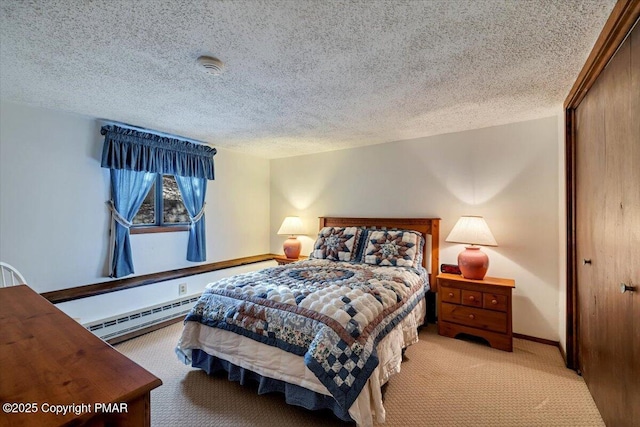 bedroom with baseboards, a baseboard radiator, a textured ceiling, carpet floors, and a closet