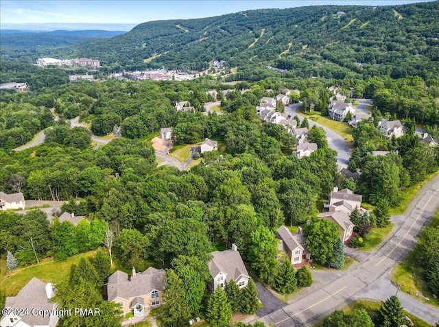 bird's eye view featuring a residential view, a view of trees, and a mountain view