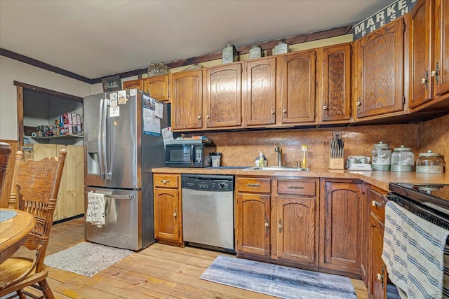 446 Dew Drop Dr, Jim Thorpe, PA 18229 - kitchen featuring appliances with stainless steel finishes, brown cabinets, light wood-type flooring, light countertops, and backsplash