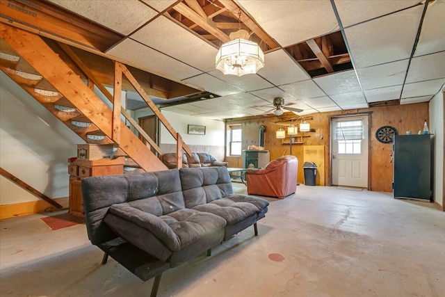 446 Dew Drop Dr, Jim Thorpe, PA 18229 - basement featuring healthy amount of natural light, stairs, wooden walls, a ceiling fan, and a drop ceiling