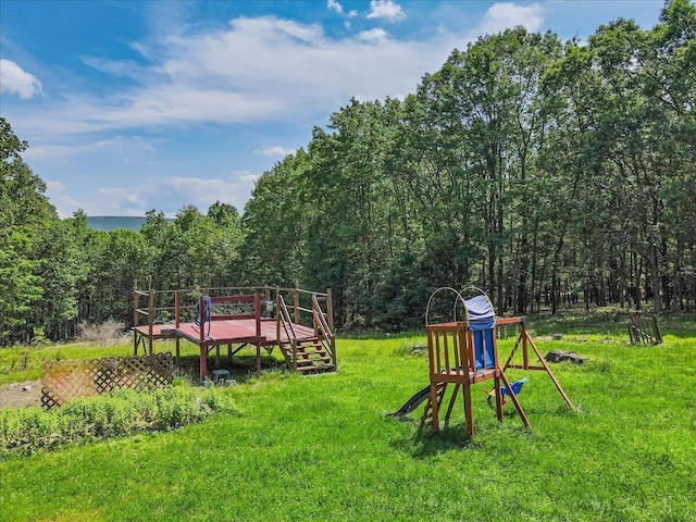446 Dew Drop Dr, Jim Thorpe, PA 18229 - view of playground with a deck, a forest view, and a lawn