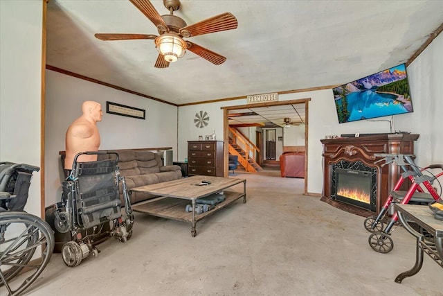 446 Dew Drop Dr, Jim Thorpe, PA 18229 - living area with concrete flooring, a glass covered fireplace, ceiling fan, stairs, and ornamental molding