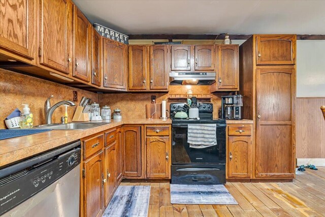 446 Dew Drop Dr, Jim Thorpe, PA 18229 - kitchen featuring stainless steel dishwasher, under cabinet range hood, black range with electric stovetop, brown cabinets, and light countertops