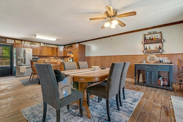 446 Dew Drop Dr, Jim Thorpe, PA 18229 - dining area with wainscoting, wooden walls, light wood finished floors, ceiling fan, and crown molding