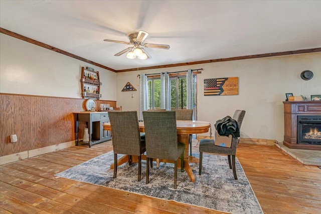 446 Dew Drop Dr, Jim Thorpe, PA 18229 - dining area with hardwood / wood-style flooring, a ceiling fan, wainscoting, wooden walls, and ornamental molding