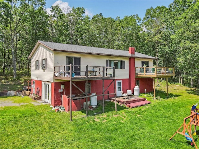 446 Dew Drop Dr, Jim Thorpe, PA 18229 - rear view of property featuring a wooden deck, a yard, a chimney, and view of scattered trees