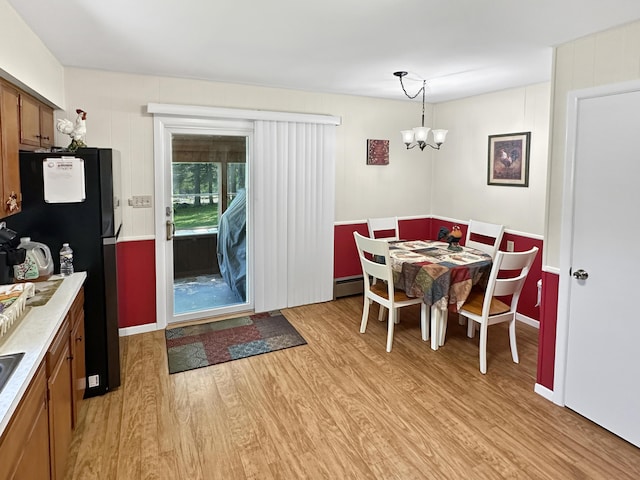 7537 Lake Shore Dr, Pocono Lake, PA 18347 - dining space featuring a chandelier, light wood-style flooring, and baseboard heating