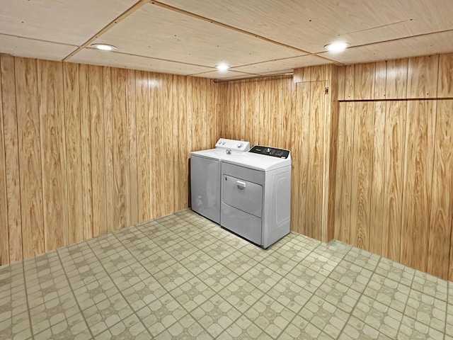 7537 Lake Shore Dr, Pocono Lake, PA 18347 - laundry area featuring washer and clothes dryer, tile patterned floors, and wooden walls