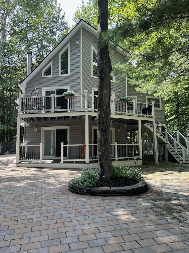 rear view of house featuring stairs