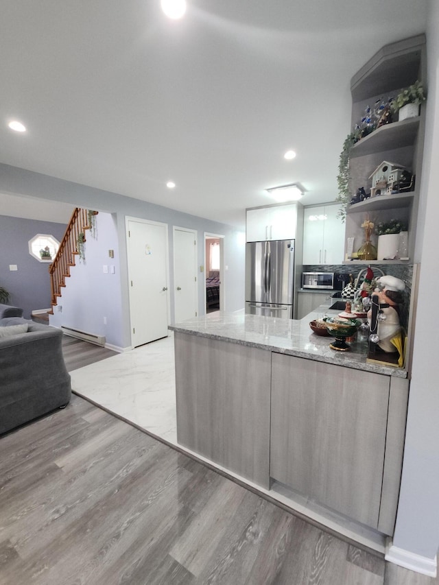 419 Quaker Ct, Pocono Lake, PA 18347 - kitchen featuring appliances with stainless steel finishes, a peninsula, open shelves, light stone counters, and recessed lighting