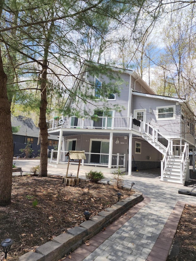 419 Quaker Ct, Pocono Lake, PA 18347 - back of property with covered porch and stairway