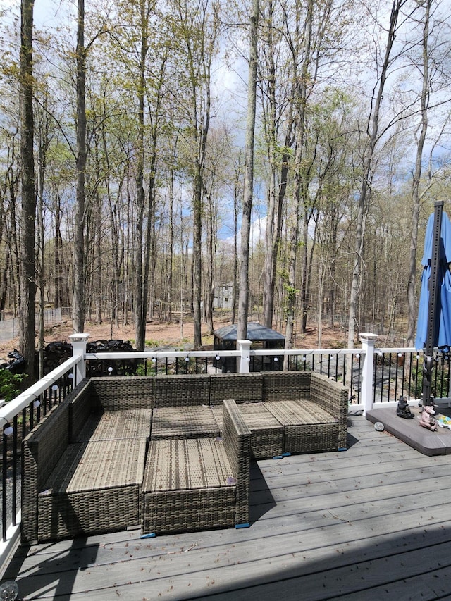 419 Quaker Ct, Pocono Lake, PA 18347 - wooden deck with an outdoor living space and view of wooded area
