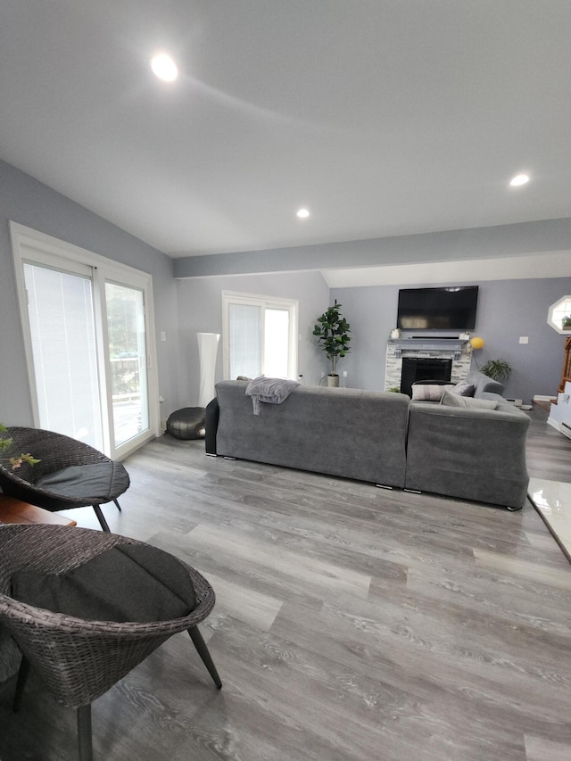 419 Quaker Ct, Pocono Lake, PA 18347 - living room with wood finished floors, plenty of natural light, a stone fireplace, and recessed lighting