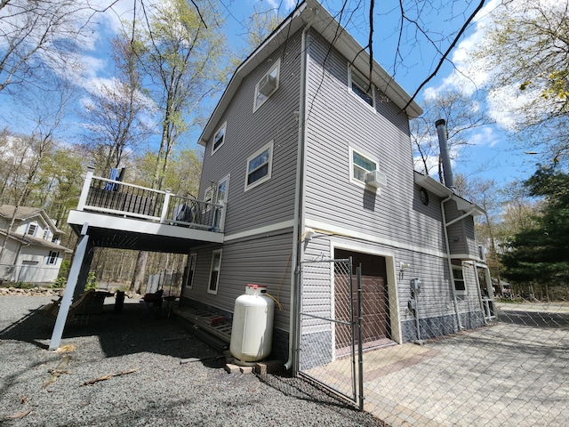 419 Quaker Ct, Pocono Lake, PA 18347 - view of side of property with an attached garage, driveway, fence, and a wooden deck
