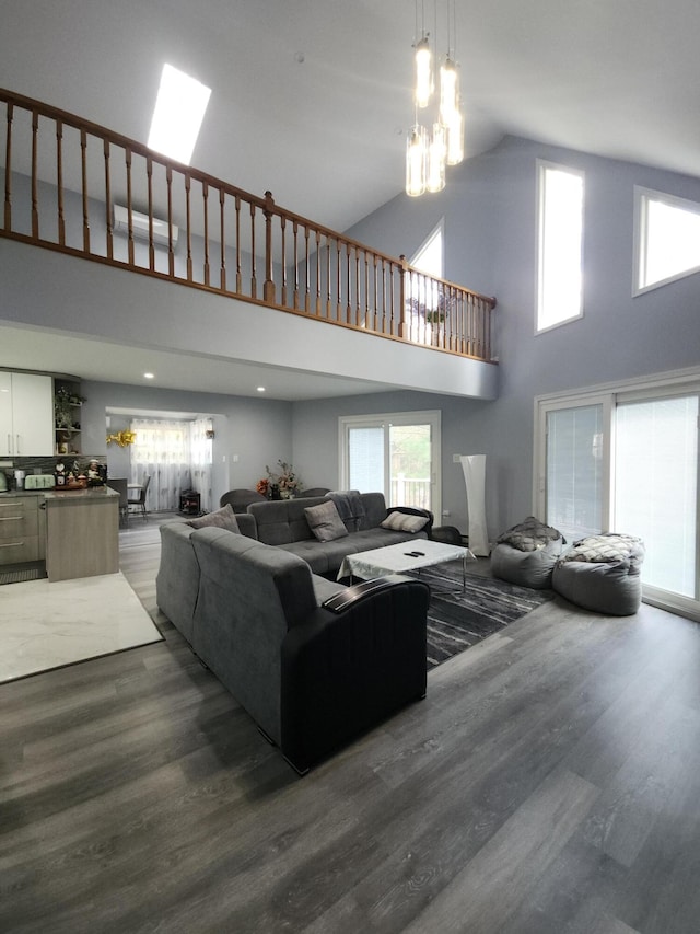 419 Quaker Ct, Pocono Lake, PA 18347 - living room with wood finished floors, high vaulted ceiling, plenty of natural light, and a chandelier