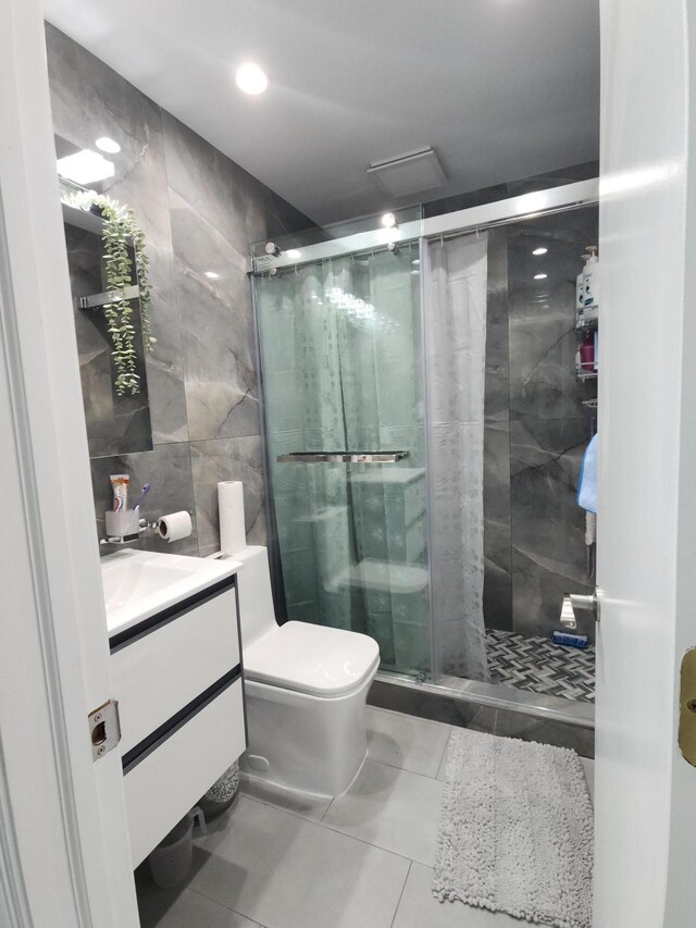419 Quaker Ct, Pocono Lake, PA 18347 - full bath featuring tile walls, tile patterned flooring, vanity, a shower stall, and toilet