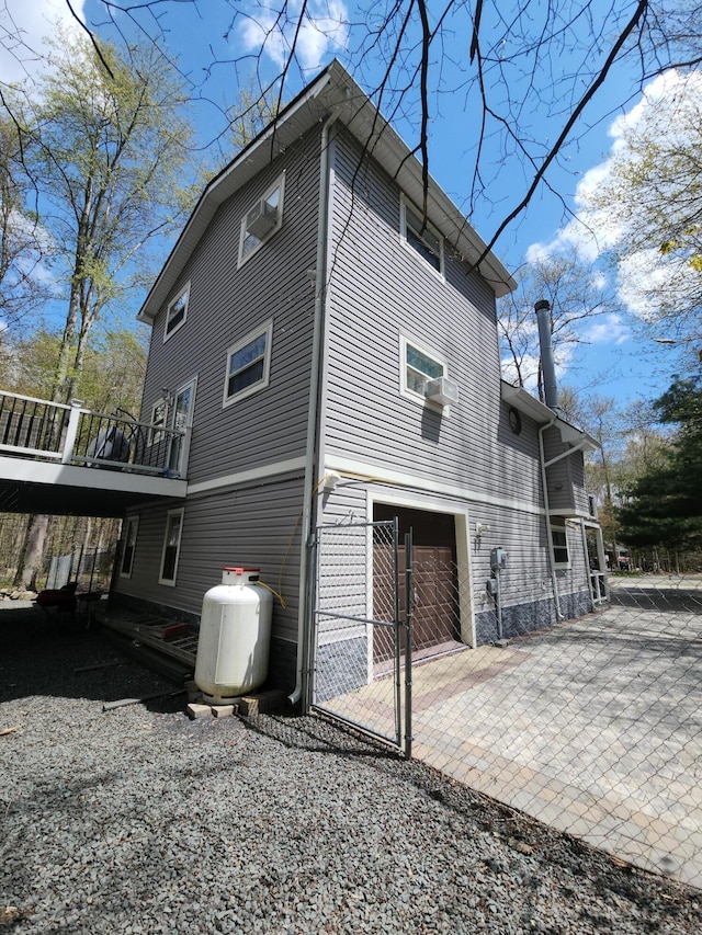 419 Quaker Ct, Pocono Lake, PA 18347 - view of side of home featuring a garage, driveway, and a deck