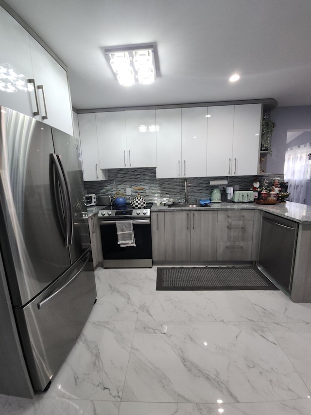 419 Quaker Ct, Pocono Lake, PA 18347 - kitchen with stainless steel appliances, decorative backsplash, white cabinets, a sink, and modern cabinets