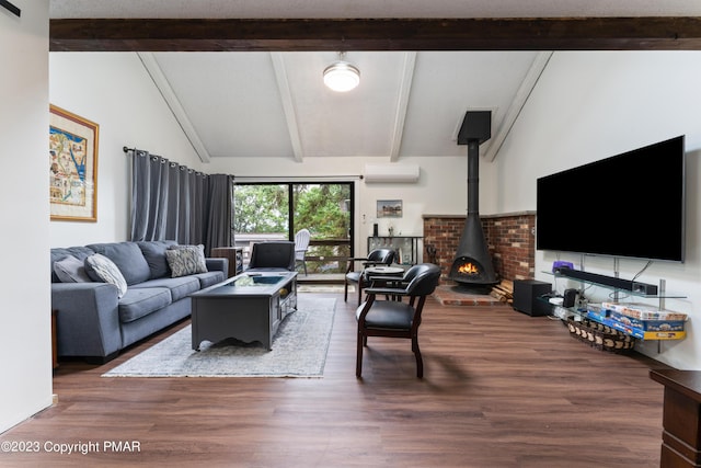 living room with lofted ceiling with beams, a wall unit AC, wood finished floors, and a wood stove