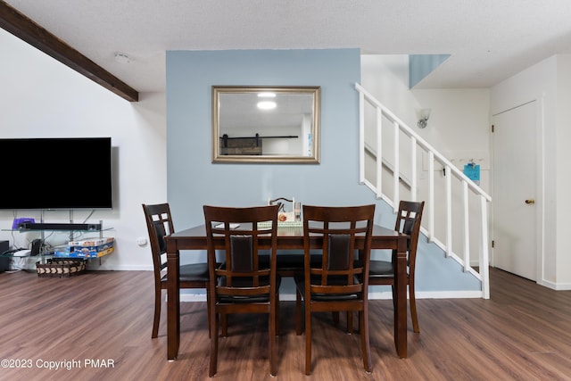 dining space with a textured ceiling, stairway, wood finished floors, and baseboards