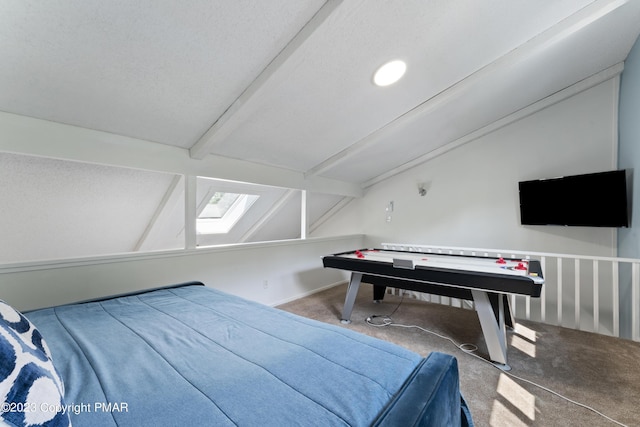 carpeted bedroom with vaulted ceiling with beams