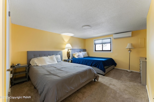 carpeted bedroom with a wall unit AC, a textured ceiling, and baseboards