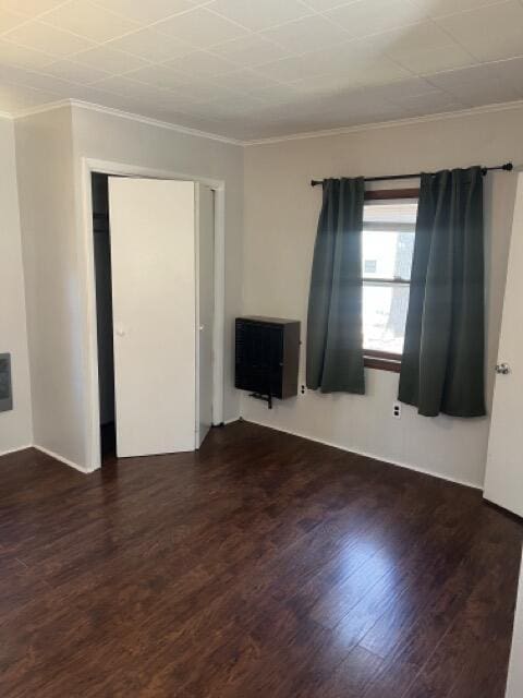 unfurnished room featuring wood finished floors and ornamental molding