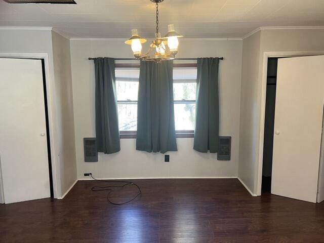 interior space with an inviting chandelier, wood finished floors, and crown molding