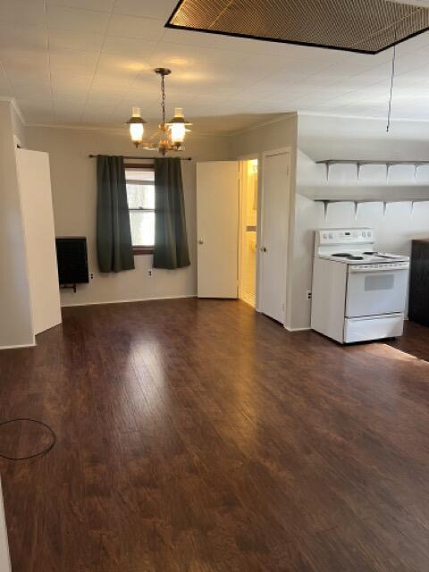 interior space featuring dark wood-style floors, crown molding, and an inviting chandelier