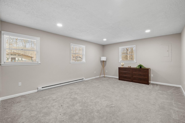 interior space featuring a baseboard heating unit, recessed lighting, baseboards, and a textured ceiling