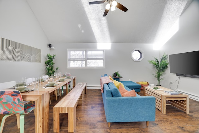 living area with wood finished floors, a baseboard radiator, ceiling fan, vaulted ceiling, and a textured ceiling