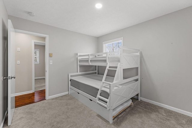 bedroom with baseboards and carpet floors