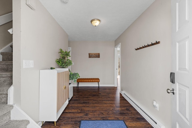 corridor featuring stairway, wood finished floors, baseboards, and a baseboard radiator