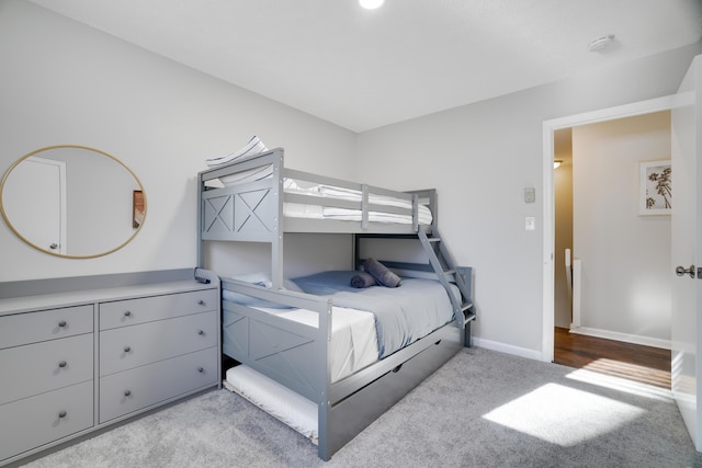 carpeted bedroom featuring baseboards