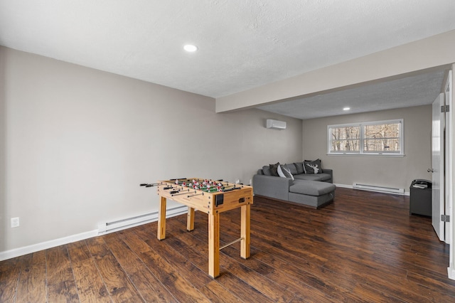 game room with baseboards, dark wood-style flooring, and baseboard heating