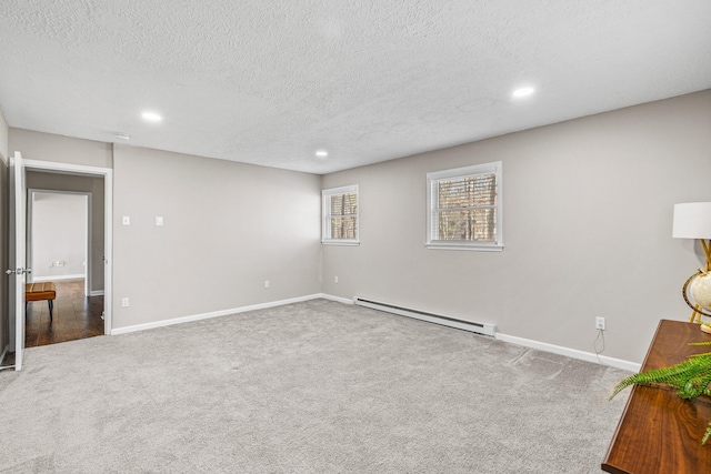 interior space with recessed lighting, a textured ceiling, baseboards, and a baseboard radiator