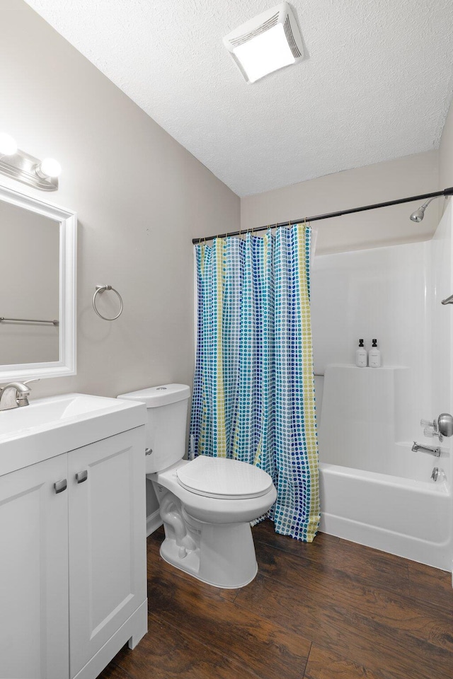 full bath with vanity, wood finished floors, visible vents, shower / bath combo, and toilet