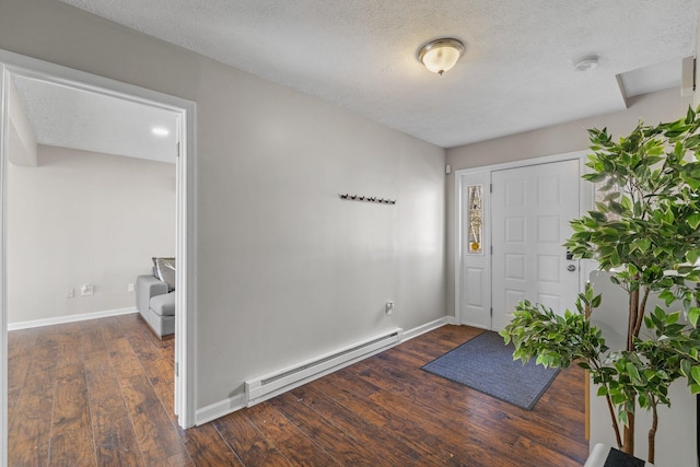 entrance foyer featuring a textured ceiling, dark wood-style floors, baseboards, and a baseboard radiator